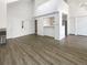 Spacious living area featuring wood floors, high ceilings, a breakfast bar, and large windows offering natural light at 6731 S Ivy Way # B4, Centennial, CO 80112