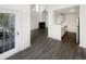 Open-concept living room with fireplace, gray flooring, and kitchen view, perfect for modern living at 6731 S Ivy Way # B4, Centennial, CO 80112