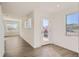 Bright and airy entryway with hardwood floors and view into the living area at 15243 W 69Th Ave, Arvada, CO 80007