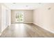 A large, bright basement room features light wood floors and glass doors leading to the backyard at 6535 Balsam St, Arvada, CO 80004