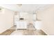 Basement kitchen with white appliances, ample counter space, and tiled floors at 6535 Balsam St, Arvada, CO 80004
