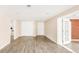 Spacious basement room featuring durable laminate floors, bright lighting, and convenient closet space at 6535 Balsam St, Arvada, CO 80004