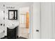 Bathroom featuring a sink, an ornate mirror and a door leading to storage room at 6535 Balsam St, Arvada, CO 80004