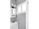 Bathroom features a modern sink and vanity, updated light fixtures, and a bright window at 6535 Balsam St, Arvada, CO 80004