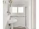 Bathroom featuring a pedestal sink, tiled floor, window, and enclosed shower stall at 6535 Balsam St, Arvada, CO 80004