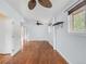 Room with hardwood flooring, ceiling fans, and multiple windows at 6535 Balsam St, Arvada, CO 80004
