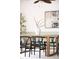 Dining room featuring a wooden table with black chairs, white vase, modern art, and a ceiling fan, creating an inviting space at 6535 Balsam St, Arvada, CO 80004