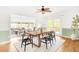 Open concept dining room with wood table and black chairs near opening to the living room at 6535 Balsam St, Arvada, CO 80004