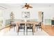 Dining room with modern decor, including a wooden table, black chairs, and a patterned rug, creating a stylish and comfortable space at 6535 Balsam St, Arvada, CO 80004