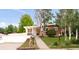 Charming brick home with well-maintained front yard, covered porch, mature trees, and an attached two-car garage at 6535 Balsam St, Arvada, CO 80004