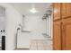 Efficient laundry room with modern washer, dryer, ample shelving, and storage cabinets for organized convenience at 6535 Balsam St, Arvada, CO 80004