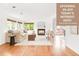 Bright living room features hardwood floors, a cozy fireplace, and natural light from large windows at 6535 Balsam St, Arvada, CO 80004