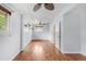 Spacious living room with hardwood floors, ample natural light, and modern ceiling fan at 6535 Balsam St, Arvada, CO 80004
