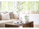 Bright living room with a comfortable sofa, natural light, and a stylish coffee table, creating a cozy and inviting atmosphere at 6535 Balsam St, Arvada, CO 80004
