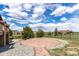 Beautifully landscaped backyard with a stone patio, perfect for outdoor gatherings at 20097 Royal Troon Dr, Monument, CO 80132