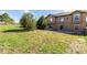 Large, grassy backyard with sliding door and fenced perimeter at 20097 Royal Troon Dr, Monument, CO 80132