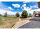 Landscaped backyard with a brick patio and a scenic view at 20097 Royal Troon Dr, Monument, CO 80132