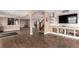Finished basement with open floor plan, recessed lighting, hardwood floors, and built-in shelves at 20097 Royal Troon Dr, Monument, CO 80132