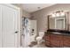 Well-lit bathroom featuring a tub with shower, wooden vanity, and neutral color scheme at 20097 Royal Troon Dr, Monument, CO 80132
