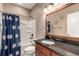 Cozy bathroom featuring a shower over bath, granite counters, and wood cabinetry at 20097 Royal Troon Dr, Monument, CO 80132