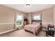 Bedroom featuring natural light, carpet, neutral walls and chair rail with a bed and tv at 20097 Royal Troon Dr, Monument, CO 80132