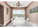 Elegant dining room with a long table, chandelier, and a large window offering scenic views at 20097 Royal Troon Dr, Monument, CO 80132