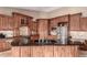 Well-equipped kitchen with custom wooden cabinets, black countertops, and stainless steel appliances at 20097 Royal Troon Dr, Monument, CO 80132