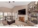 Inviting living room with stone fireplace, large TV, and view of the staircase at 20097 Royal Troon Dr, Monument, CO 80132