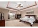 Spacious main bedroom featuring a fireplace, tray ceiling and large windows offering scenic views at 20097 Royal Troon Dr, Monument, CO 80132