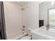 Modern bathroom with subway tile shower-tub combination, white vanity, and neutral fixtures at 2409 Court Pl, Denver, CO 80205