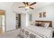 Well-lit bedroom features a ceiling fan and adjacent bathroom with sliding barn door at 2409 Court Pl, Denver, CO 80205