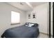 Cozy bedroom with a queen bed, contemporary art, window with blinds, and wardrobe at 2409 Court Pl, Denver, CO 80205