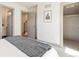 Bedroom showcasing a queen bed, modern decor, staircase access, and a view into the walk-in closet at 2409 Court Pl, Denver, CO 80205