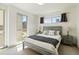 Bright bedroom featuring a queen bed, bedside tables and large windows letting in natural light at 2409 Court Pl, Denver, CO 80205