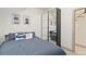 Comfortable bedroom featuring a queen bed, modern decor, and mirrored closet doors at 2409 Court Pl, Denver, CO 80205