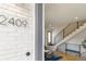 Welcoming entryway featuring an open staircase, hardwood floors, and modern design elements at 2409 Court Pl, Denver, CO 80205