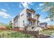 Modern townhome featuring a sleek design with a balcony, contemporary finishes, and professionally landscaped yard at 2409 Court Pl, Denver, CO 80205