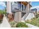 Modern townhome entrance with a balcony, showcasing contemporary design and well-maintained landscaping at 2409 Court Pl, Denver, CO 80205