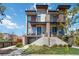Modern townhome featuring a sleek design with balconies and professionally landscaped yard at 2409 Court Pl, Denver, CO 80205