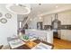 Open-concept kitchen with stainless appliances, breakfast bar, and dining area at 2409 Court Pl, Denver, CO 80205