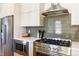 Gourmet kitchen boasts stainless steel appliances, gas range, and sleek cabinetry at 2409 Court Pl, Denver, CO 80205