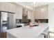 Spacious kitchen with stainless appliances, an island with bar seating, and modern lighting at 2409 Court Pl, Denver, CO 80205