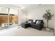 Cozy living room with plush seating, modern décor, and a sliding glass door to the backyard at 2409 Court Pl, Denver, CO 80205