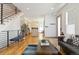 Open-concept living room and kitchen featuring hardwood floors, modern appliances, and stylish decor at 2409 Court Pl, Denver, CO 80205