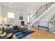 Inviting living room featuring hardwood floors, a modern staircase, and plenty of natural light at 2409 Court Pl, Denver, CO 80205