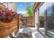 Cozy patio area with a table, chairs, wooden fence, and hanging flower baskets under string lights at 2409 Court Pl, Denver, CO 80205