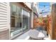 Relaxing outdoor patio with decorative lights, dining table, and potted flowers at 2409 Court Pl, Denver, CO 80205