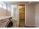 A laundry room and bathroom are visible from a basement featuring a modern washer at 1945 Nome St, Aurora, CO 80010