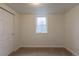A carpeted basement bedroom features a small window and a closet for efficient space utilization at 1945 Nome St, Aurora, CO 80010
