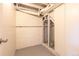 Unfinished basement closet features exposed pipes and beams providing ample storage space at 1945 Nome St, Aurora, CO 80010